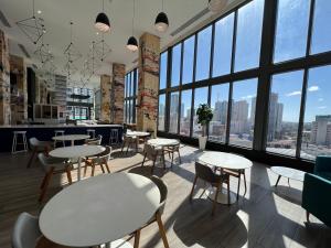 a restaurant with tables and chairs and large windows at Apartment in Miami downtown in Miami