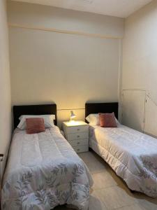 two beds sitting next to each other in a bedroom at Temporario Aguilares in Aguilares