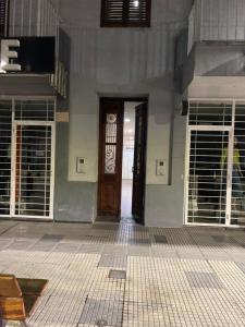 a front door of a building with two windows at Temporario Aguilares in Aguilares