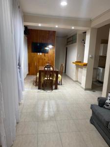a living room with a table and a couch at Temporario Aguilares in Aguilares