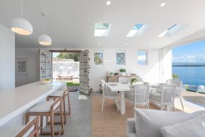 a kitchen and dining room with a view of the water at The Boathouse in Bonnells Bay