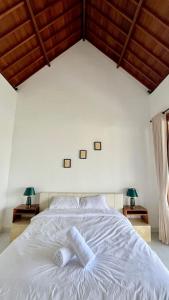 Postel nebo postele na pokoji v ubytování Sariuma babadan