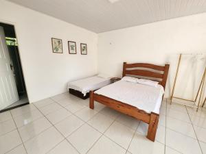 a bedroom with two beds in a room at Casa de Praia Araçagy in Macajatuba