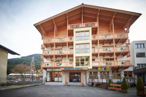 a large building with a balcony on top of it at Appartement Bretterbude in Saalbach Hinterglemm