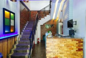 a staircase in a building with a brick wall at Estancia Roadside Inn by RedDoorz in Estancia