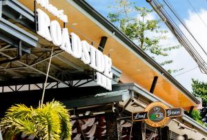 a sign on the side of a restaurant at Estancia Roadside Inn by RedDoorz in Estancia +7 photos