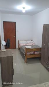 a bedroom with a bed and a wooden cabinet at Apartamento Moderno Fonavi in Talara