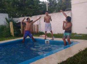 a group of men standing in a swimming pool at Quinta Mi angel in La Reja