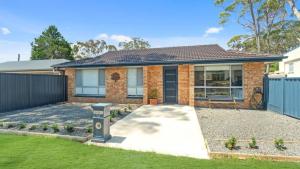 ein Backsteinhaus mit einer Einfahrt davor in der Unterkunft Woodhill Cottage in Worrowing Heights