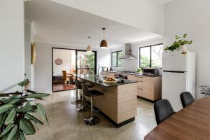 a kitchen with a refrigerator and a table with chairs at Karri Keep - Spacious 3 Bedroom Town Villa in Margaret River Town