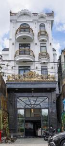 a large white building with a goldvisor over a doorway at Q Villa Hotel in Xuan An
