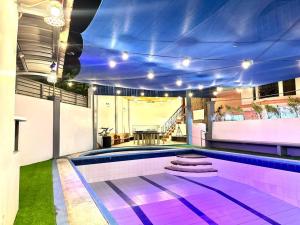 a swimming pool with purple lighting in a house at Resort in Los Banos near Pansol in Los Baños +12 photos