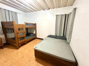 a small room with a bed and a shelf at Resort in Los Banos near Pansol in Los Baños