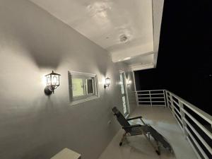 a chair sitting on a balcony with a stair case at Pinky's Beach House in Victoria +7 photos