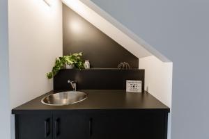 a bathroom with a sink in a black counter at Karri Keep - Spacious 3 Bedroom Town Villa in Margaret River Town +32 photos