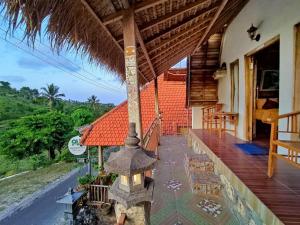 an outdoor porch of a house with a roof at The Hill Prananta in Nusa Penida