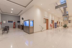 an empty hallway of a hospital with a table and chairs at Urbanview Darmo Residence Bandung in Bandung