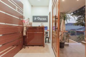 a entrance to a salon with a wooden door at Urbanview Darmo Residence Bandung in Bandung