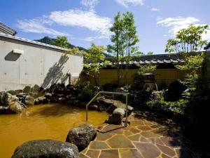 a pool of water in front of a building at Ishikin in Gifu