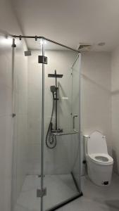 a bathroom with a shower with a toilet and a cross at Rose's Homestay Hue in Hue +10 photos