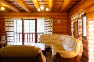 a living room with a couch and a table at Chatka u Bratka - Chalet, Stunning Mountain Views in Ždiar +36 photos