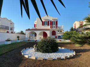 a house with a dog statue in front of it at Villa Peonia Luxury in Bisceglie