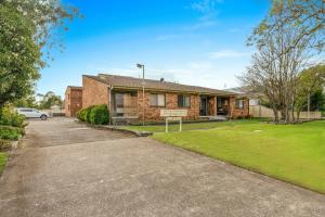 a brick house with a car parked in the driveway at 2 Cute by Experience Jervis Bay in Huskisson