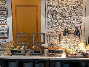 a buffet with different types of food on a table at Luxeur Jakarta - Setiabudi in Jakarta