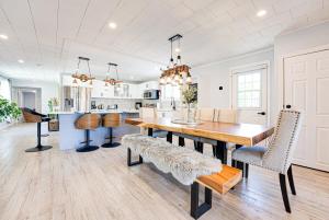 a kitchen and dining room with a wooden table and chairs at Luxury Beach Cottage - Maijac Resort & Marina in Burks Falls