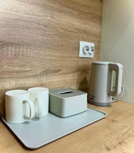 a tray with three coffee cups and a toaster at Juldyz in Zharkent +1 photo