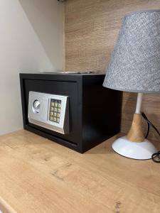 a microwave oven sitting on a table next to a lamp at Juldyz in Zharkent