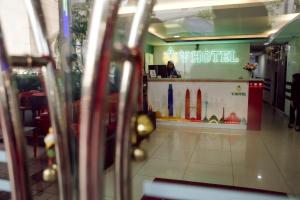 a woman sitting at a counter in a restaurant at V Hotel Titiwangsa in Kuala Lumpur