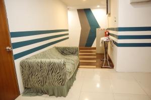 a hallway with a chair and stairs in a room at V Hotel Titiwangsa in Kuala Lumpur