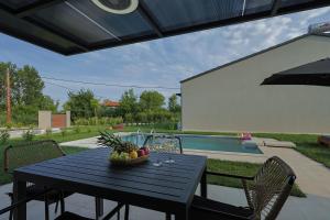 a black table with a bowl of fruit on it at Olympus Mare Village Seaside Pool Villas in Katerini