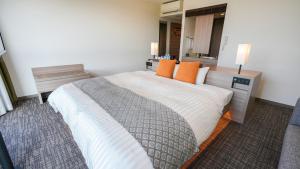 Ένα ή περισσότερα κρεβάτια σε δωμάτιο στο Airport Hotel Kumamoto