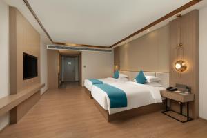 Poltton International Hotel - Chaozhou Hanjiang客房内的一张或多张床位