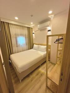 Postel nebo postele na pokoji v ubytování Dila Apart Hotel