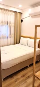 Postel nebo postele na pokoji v ubytování Dila Apart Hotel