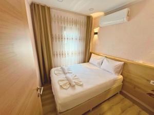 Postel nebo postele na pokoji v ubytování Dila Apart Hotel