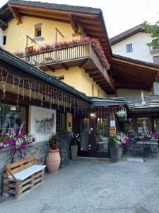 a building with a bench in front of it at Hotel Coeur Du Village in La Thuile