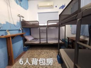 Ένα ή περισσότερα κρεβάτια σε δωμάτιο στο Huangpu Hostel