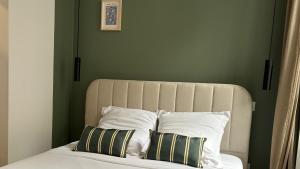 a bedroom with a bed with two pillows on it at Charlie Green in Nevers