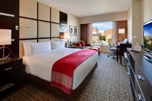 a hotel room with a large bed and a desk at The Statler Hotel at Cornell University in Ithaca