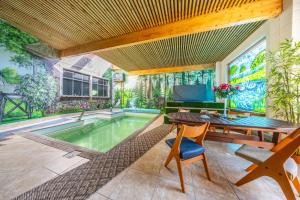 a home with a pool and a table and a chair at Spa Glamping in Kirikumõisa
