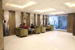 a group of people sitting in a waiting room at Hotel Gagan Suite in Kānpur