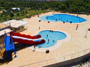 an overhead view of a large pool with people in it at Mobile Home in Cres near Pebble Beach in Cres
