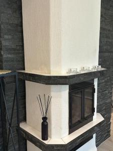 a fireplace with a vase sitting on top of it at Leviki in Levi