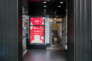 an entrance to a building with a red sign in a doorway at Saturn Hotel in Taichung