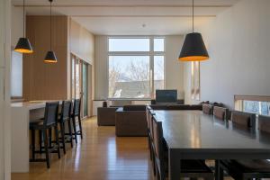 a dining room with a large table and chairs at Forest Estate in Niseko