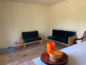 a room with two chairs and a table with a cake on a plate at J and k villa in Fort Portal +24 photos